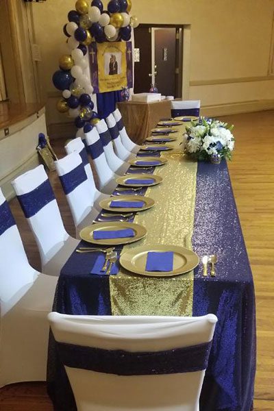 A long table with blue and gold linens